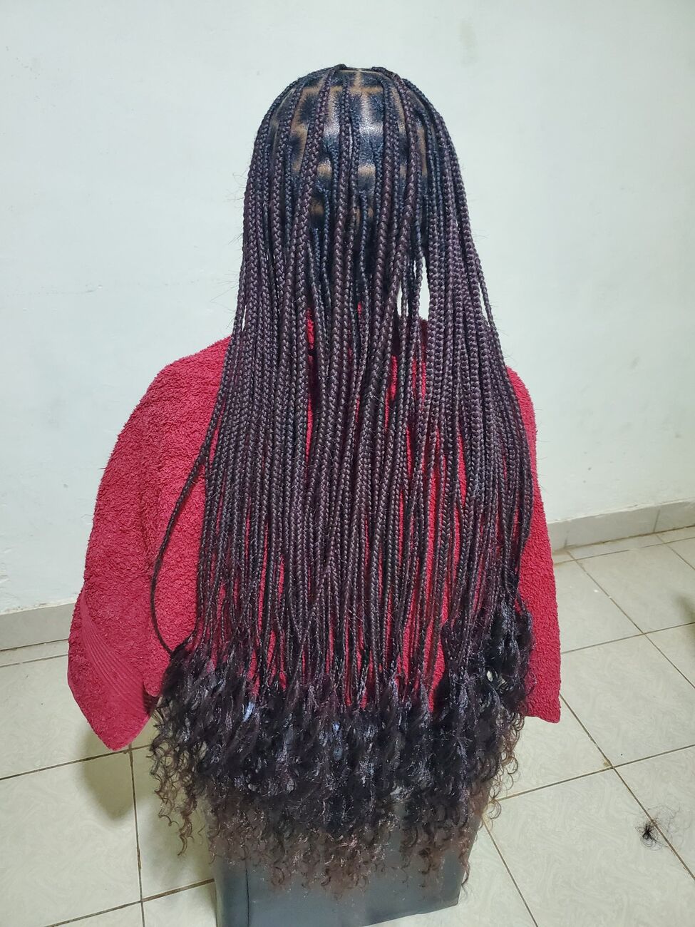 Long burgundy box braids with curled ends