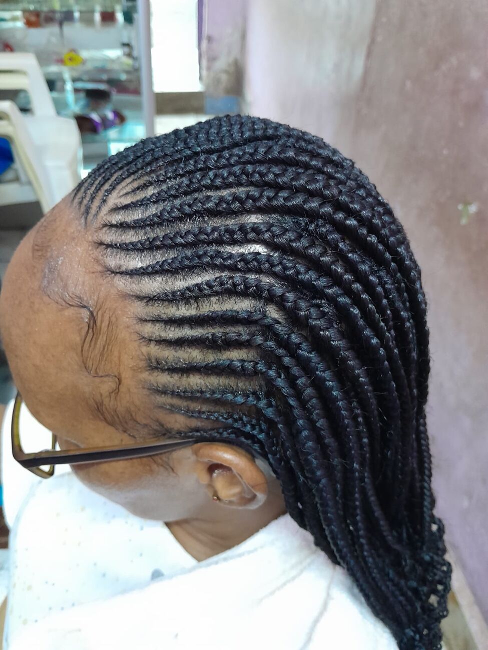 Side view of neat cornrow feed-ins